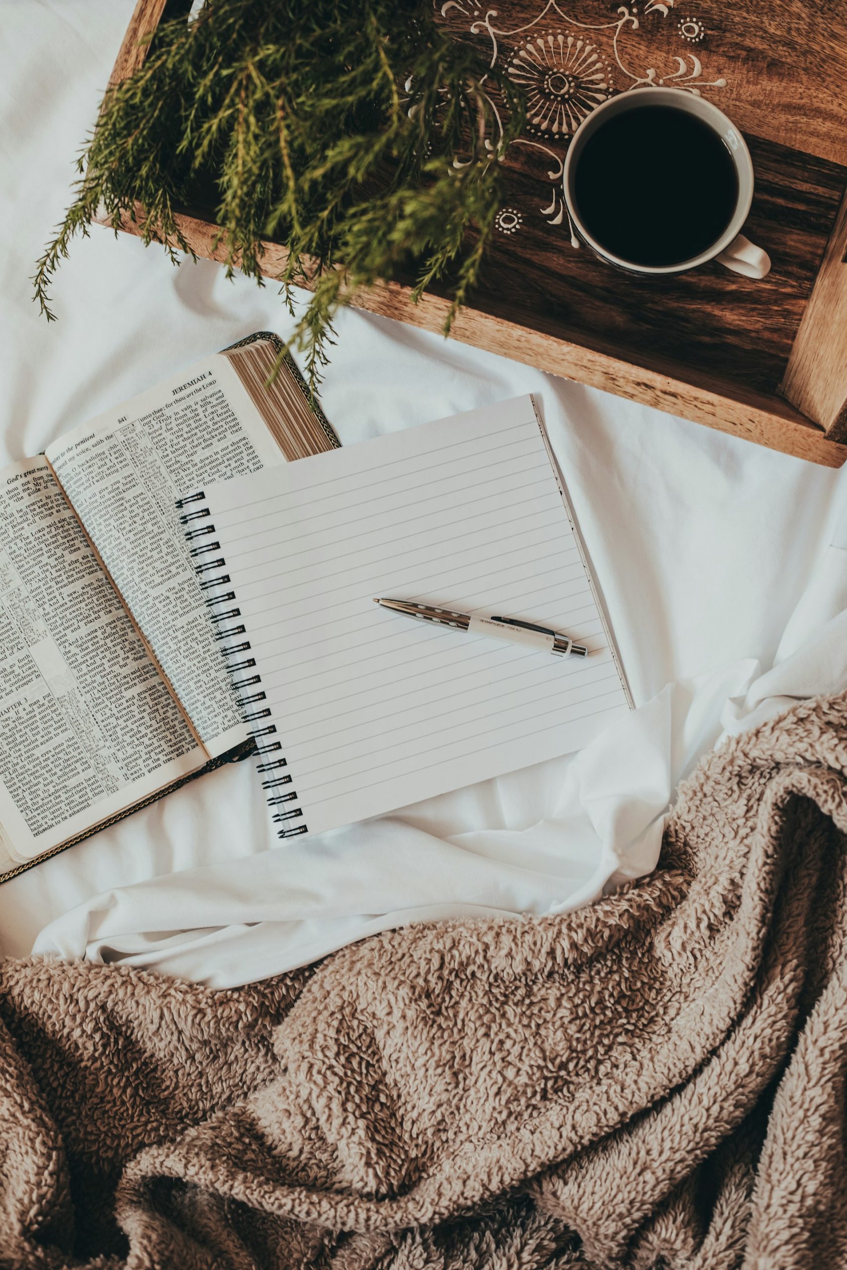 Open journal and paper materials on a soft surface